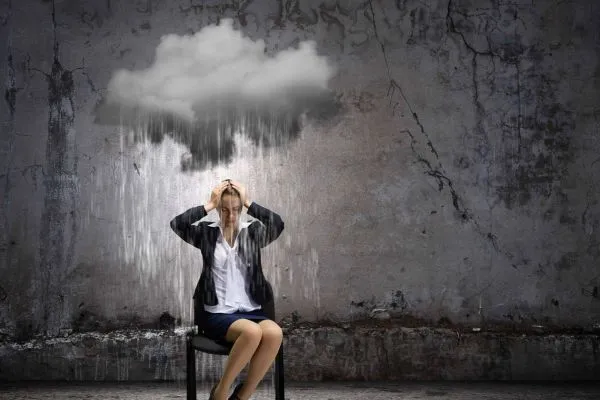 Seeking Guidance from a Numerologist - Woman sitting under dark cloud and rain